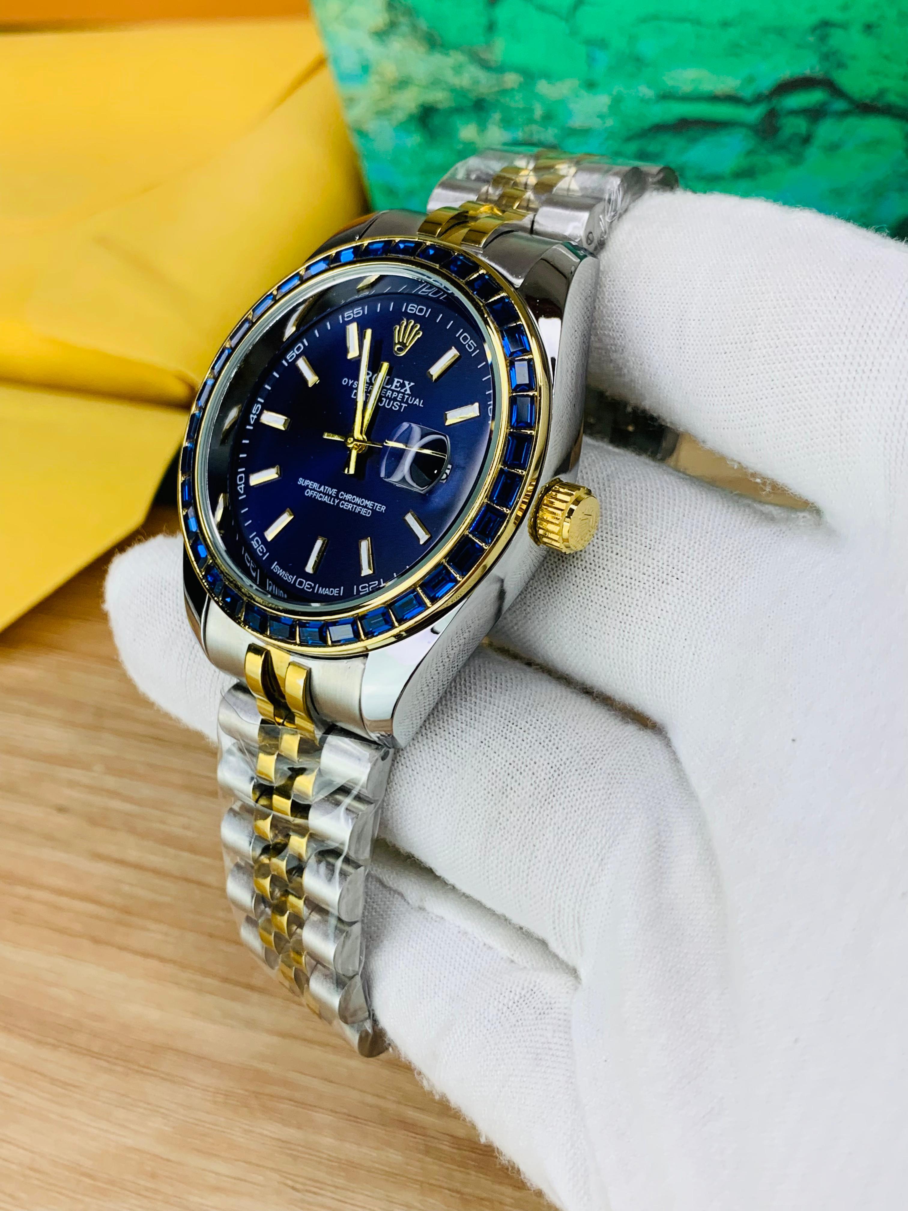 Side view of two-tone stainless steel jubilee chain watch with blue stone dial