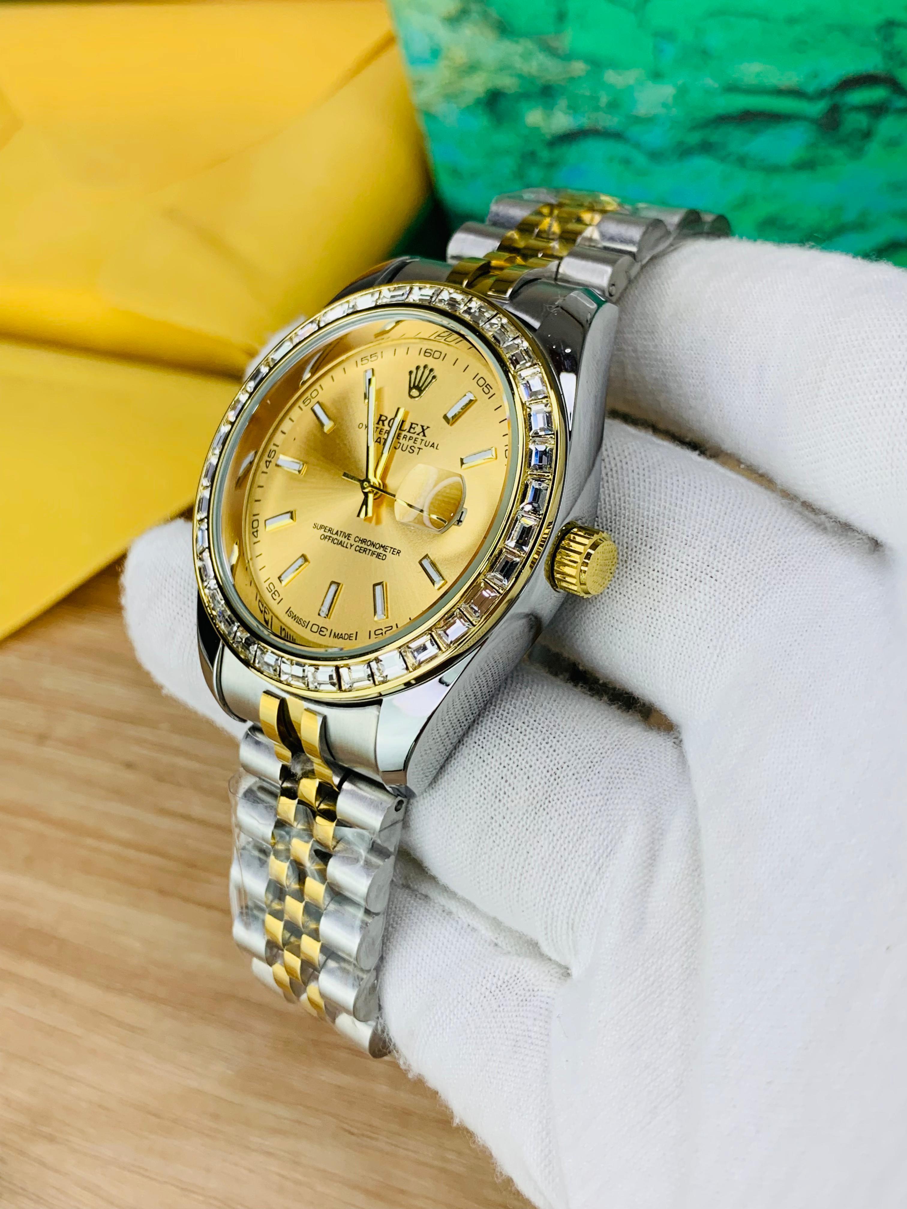 Side view of two-tone stainless steel jubilee chain watch with golden stone dial